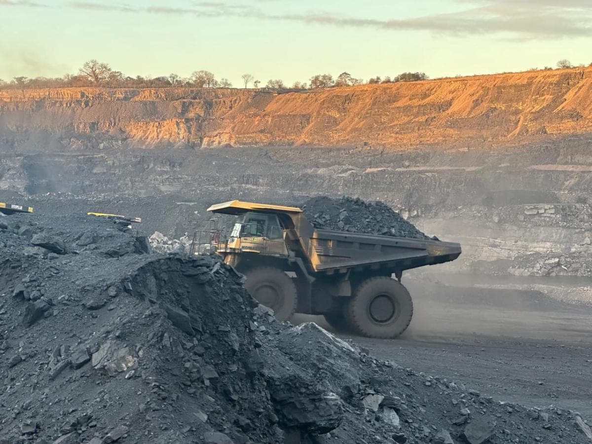 A loaded Komatsu haul truck pulling away from the loading point at first light.